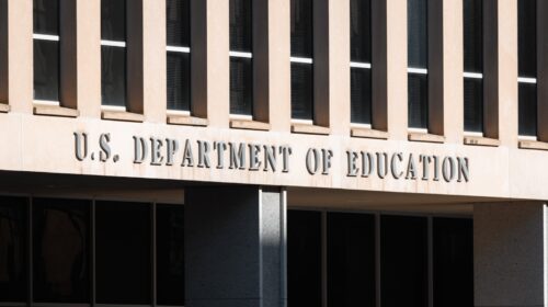 Front facade of the U.S. Department of Education building in Washington D.C., featuring large, bold letters spelling out its name.